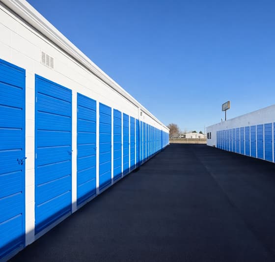Rows of blue drive-up storage unit doors at U-Stuff IT in Fort Collins